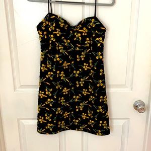 Size L Urban Outfitters black mini dress with yellow flower detailing.